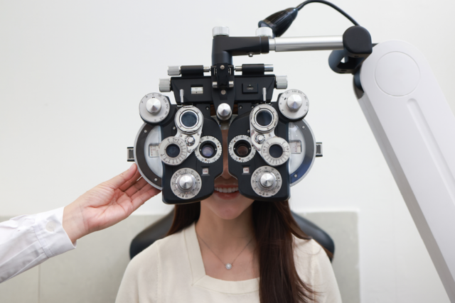 Person smiling and getting their vision checked.